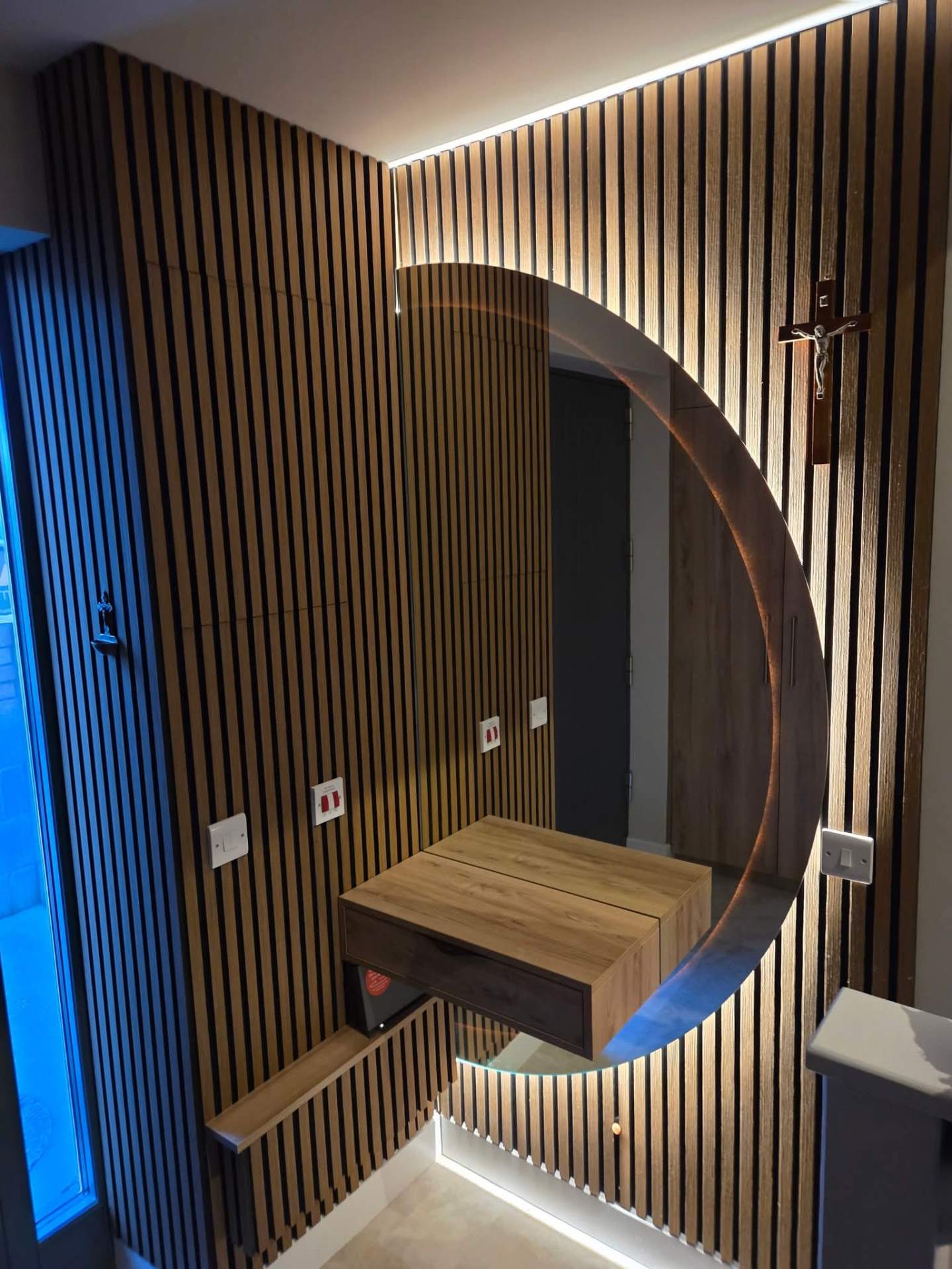 Slatted timber feature wall with floating oak vanity.